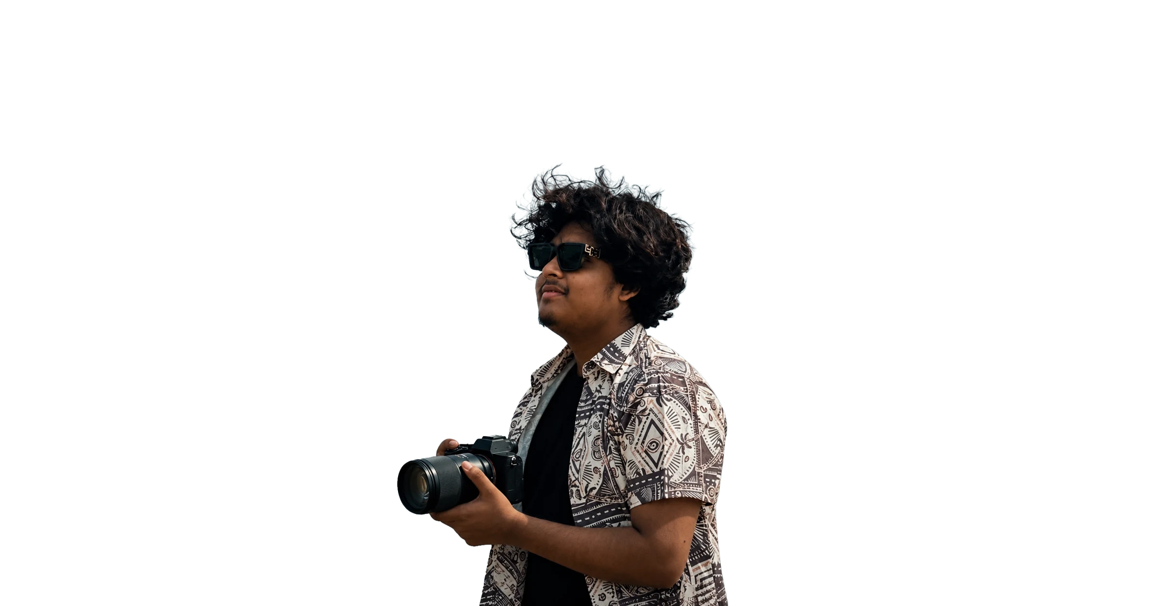 Nafiz holding a mirrorless camera under a stormy sky